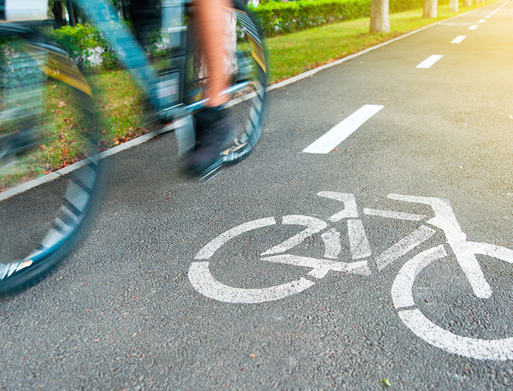 Image of person riding their bicycle on a cycle path.